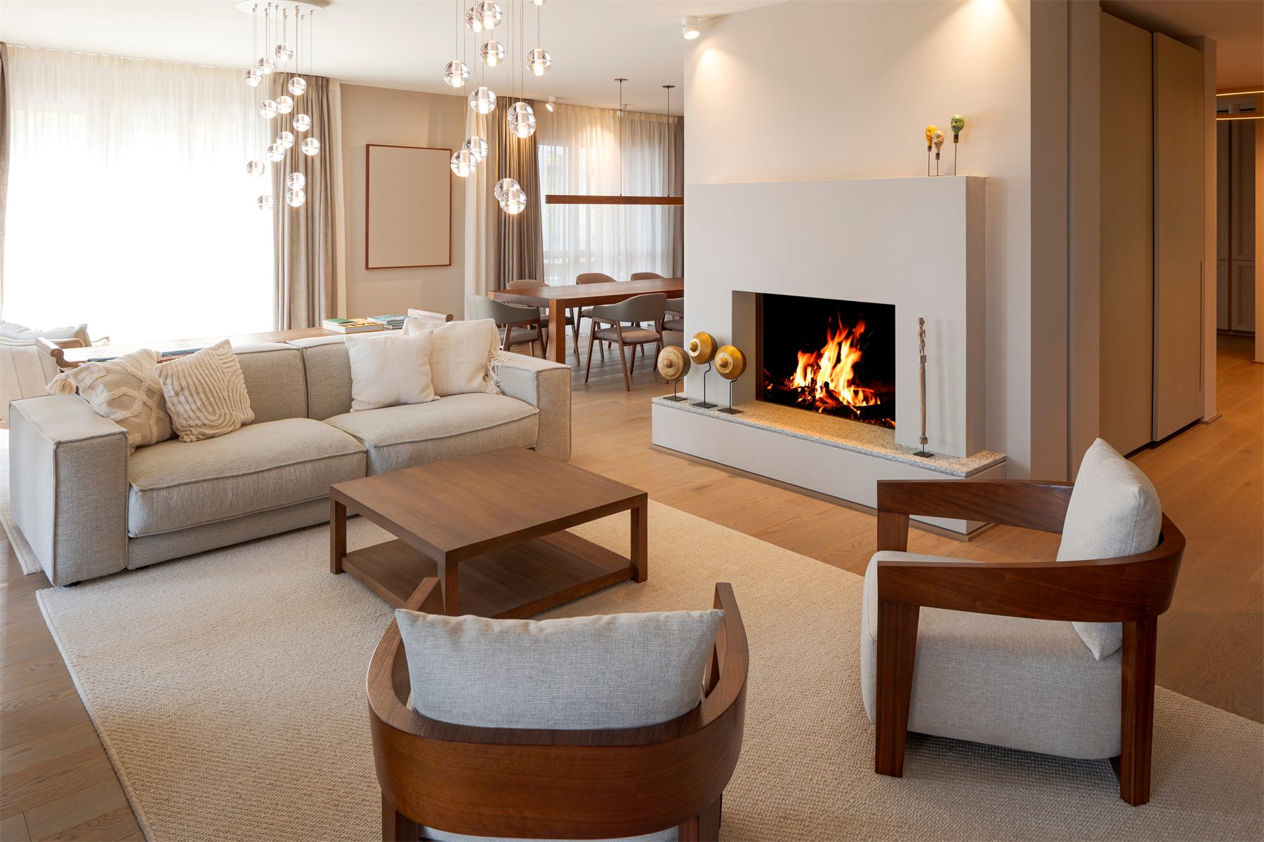 A welcoming living room with a sofa, armchairs, and a low table.