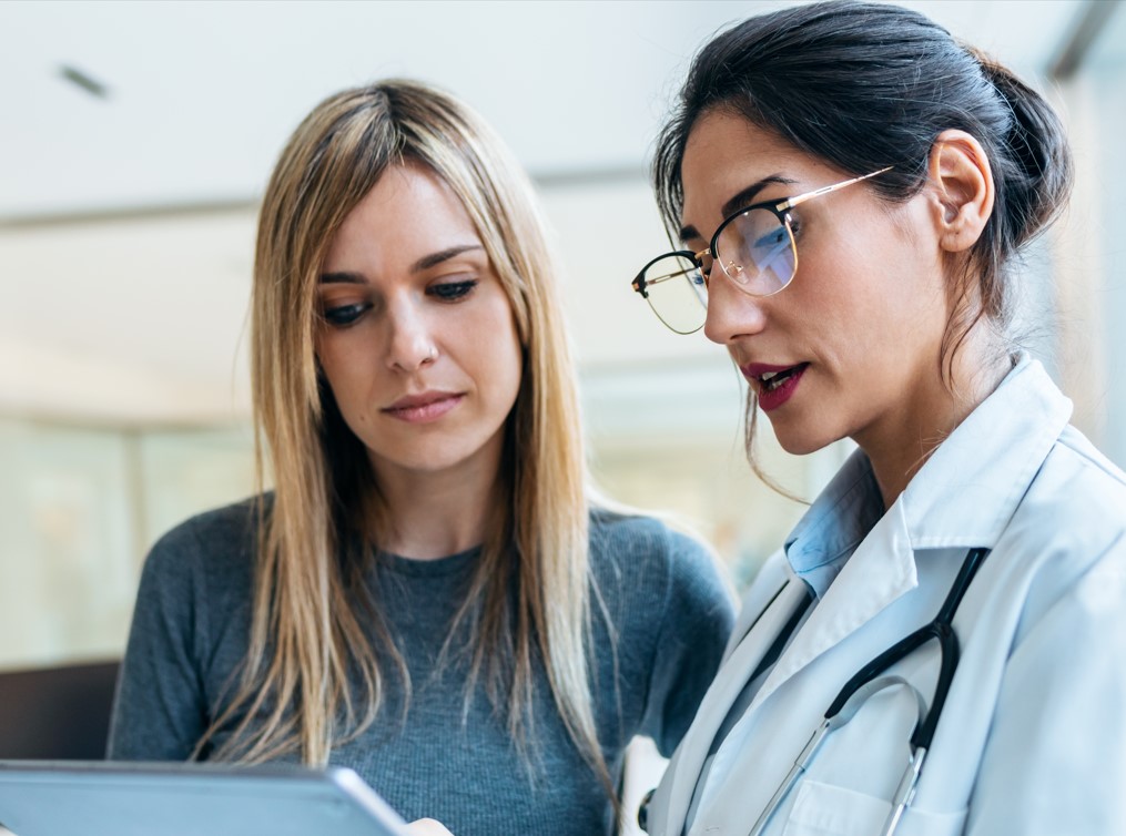 A physician and patient review information together.