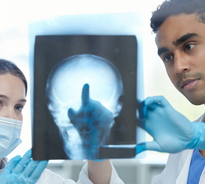 Two physicians review a medical image.