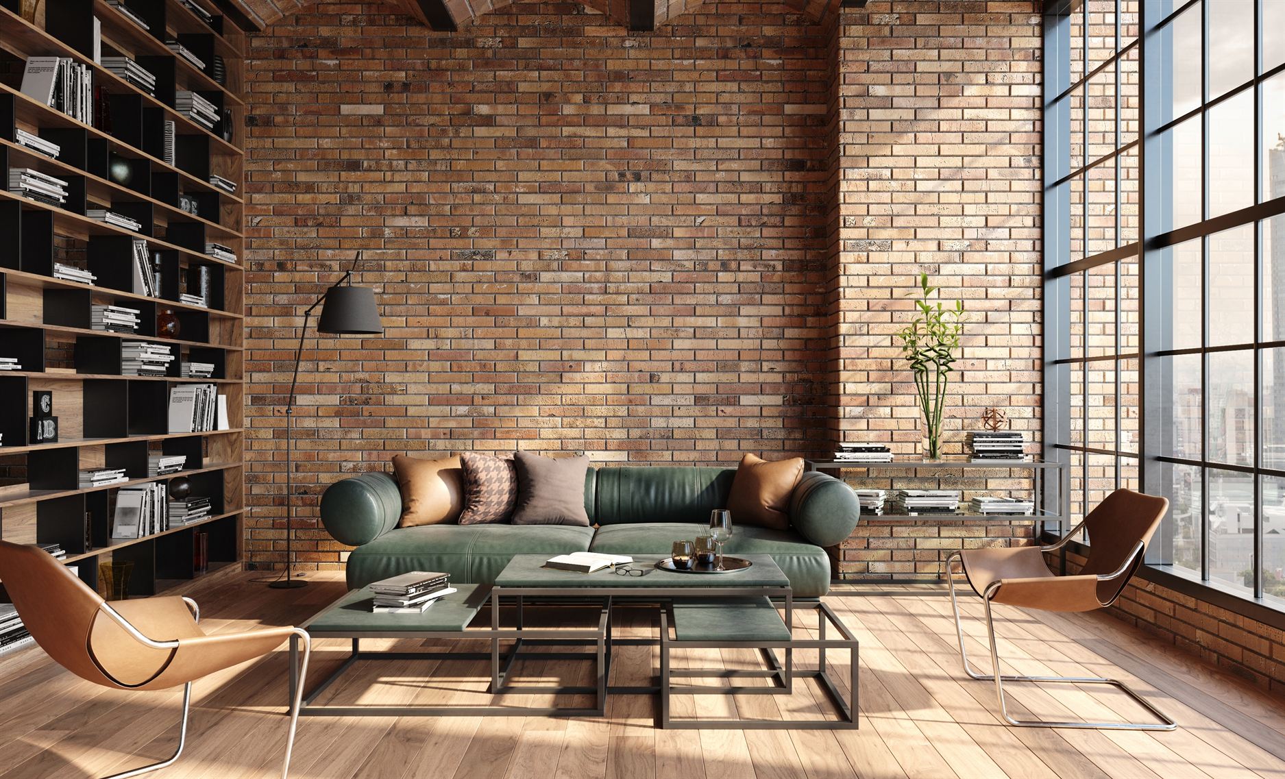 A green sofa and two chairs in a brick-walled living room.