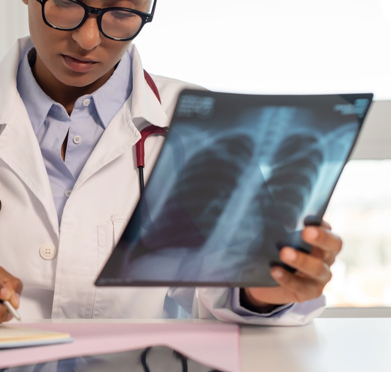 A physician reviewing a chest X-ray.